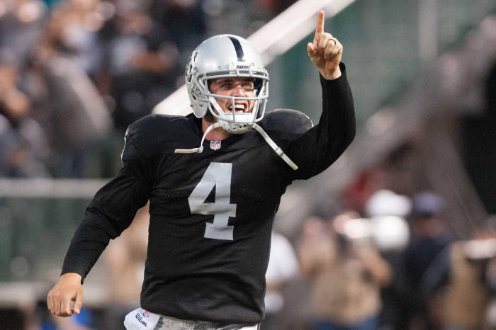 Derek Carr Points At The Sky Background