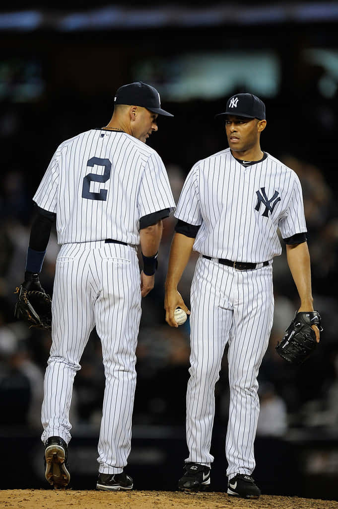 Derek Jeter Interacting With Teammate Background