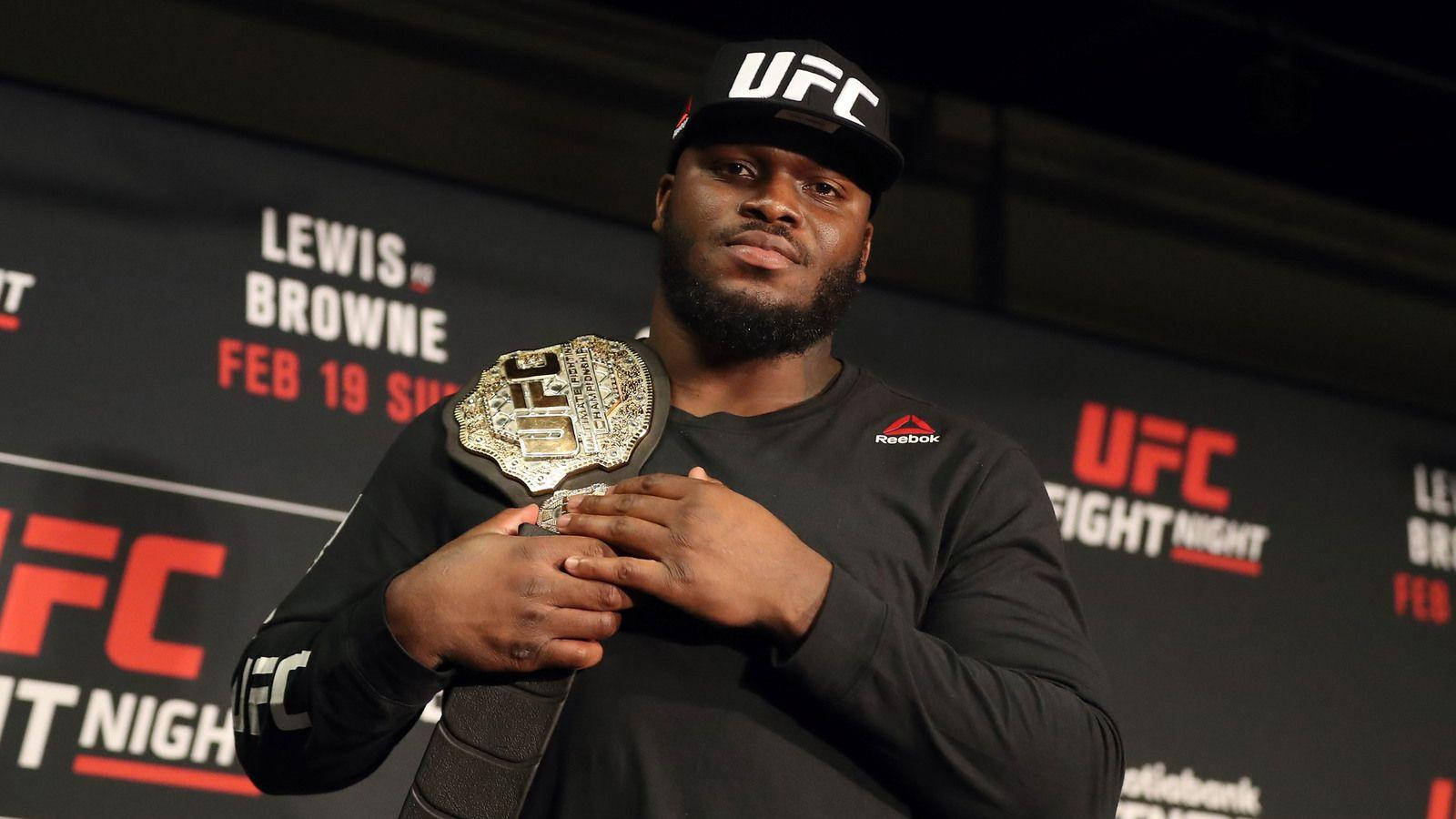 Derrick Lewis Holding Belt Background