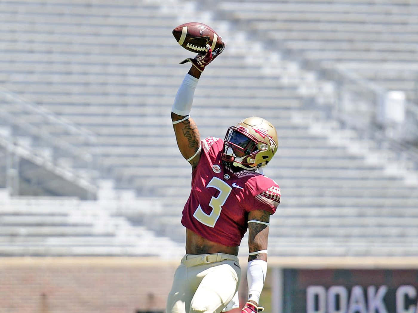 Derwin James Catching The Football Background
