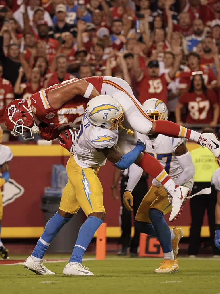 Derwin James Tackling Travis Kelce Background