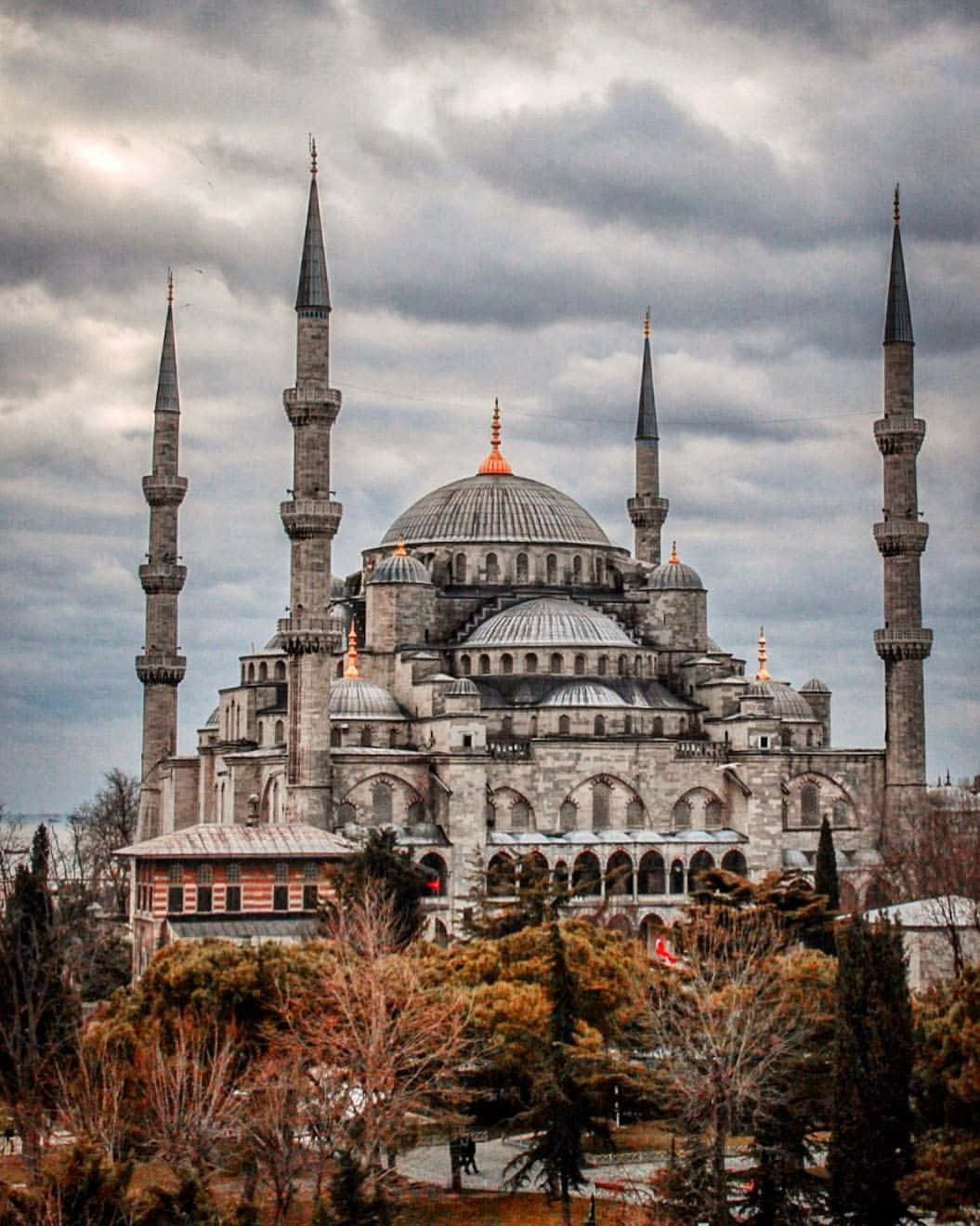 Desaturated Blue Mosque In Stormy Sky Background