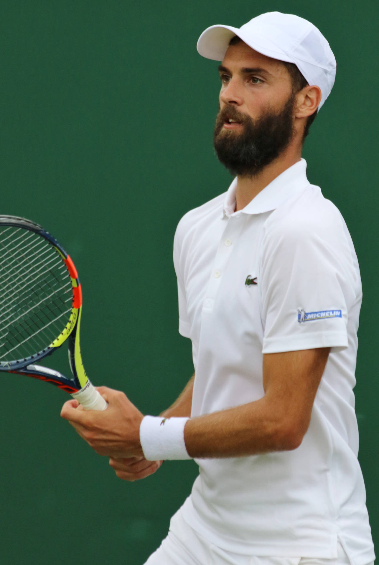 Determined Benoit Paire Gripping His Tennis Racket Background