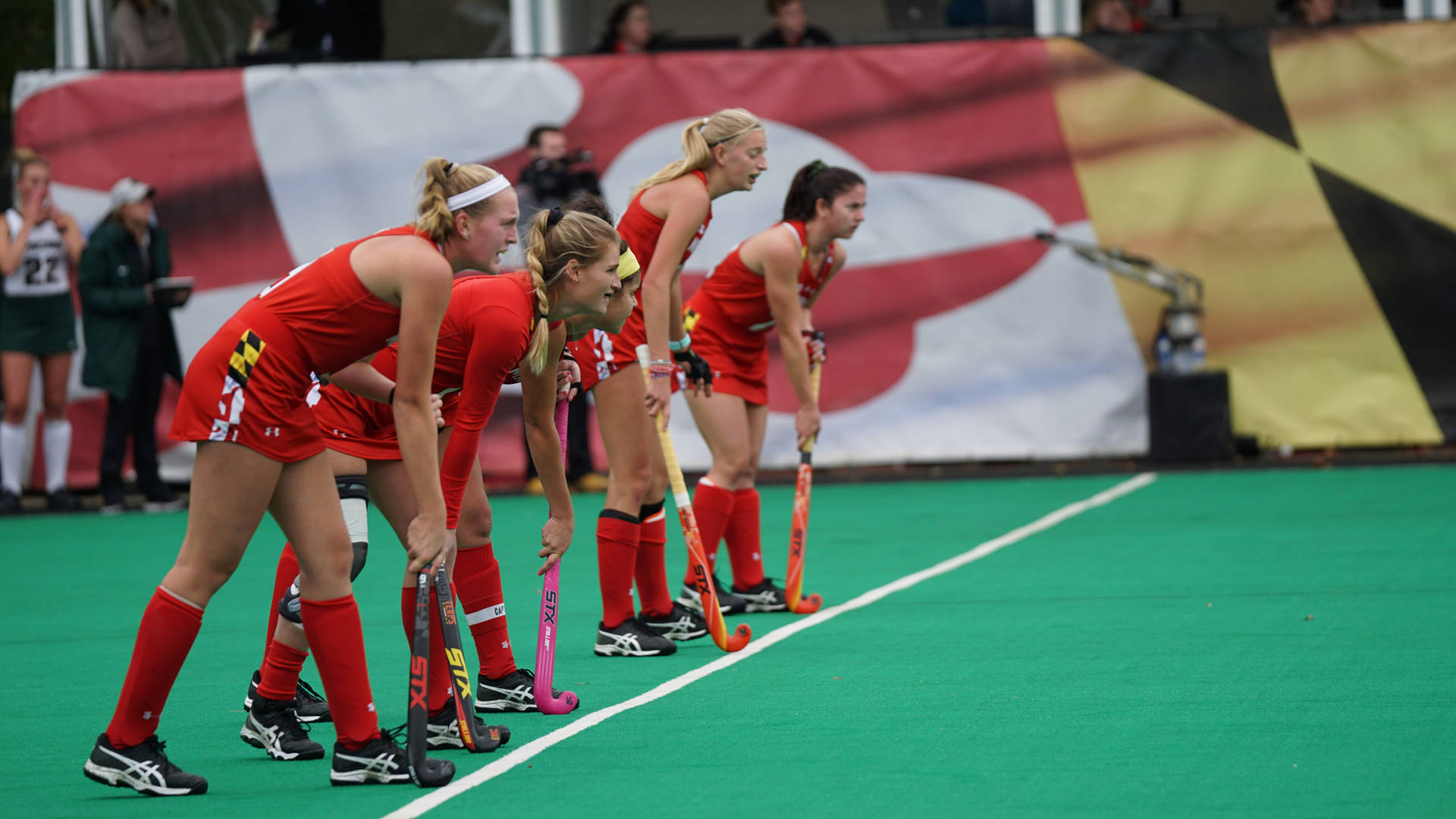 Determined Field Hockey Players Gearing Up For The Match Background