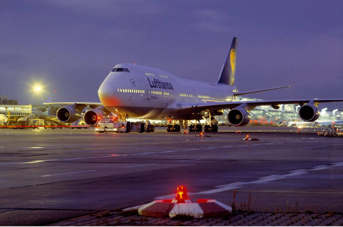 Deutsche Lufthansa Plane In Purple Twilight Background