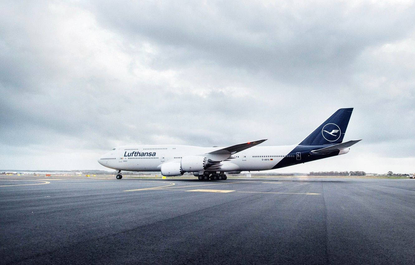 Deutsche Lufthansa Plane Under The Gray Clouds