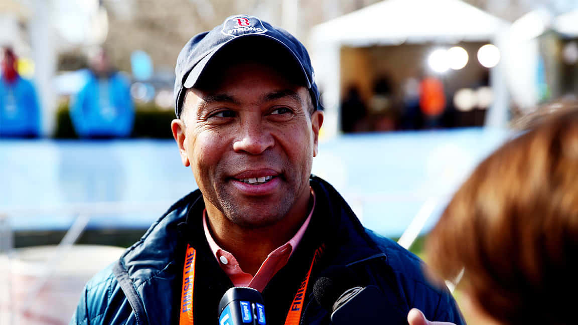 Deval Patrick, Former Massachusetts Governor, Smiling In A Cap Background