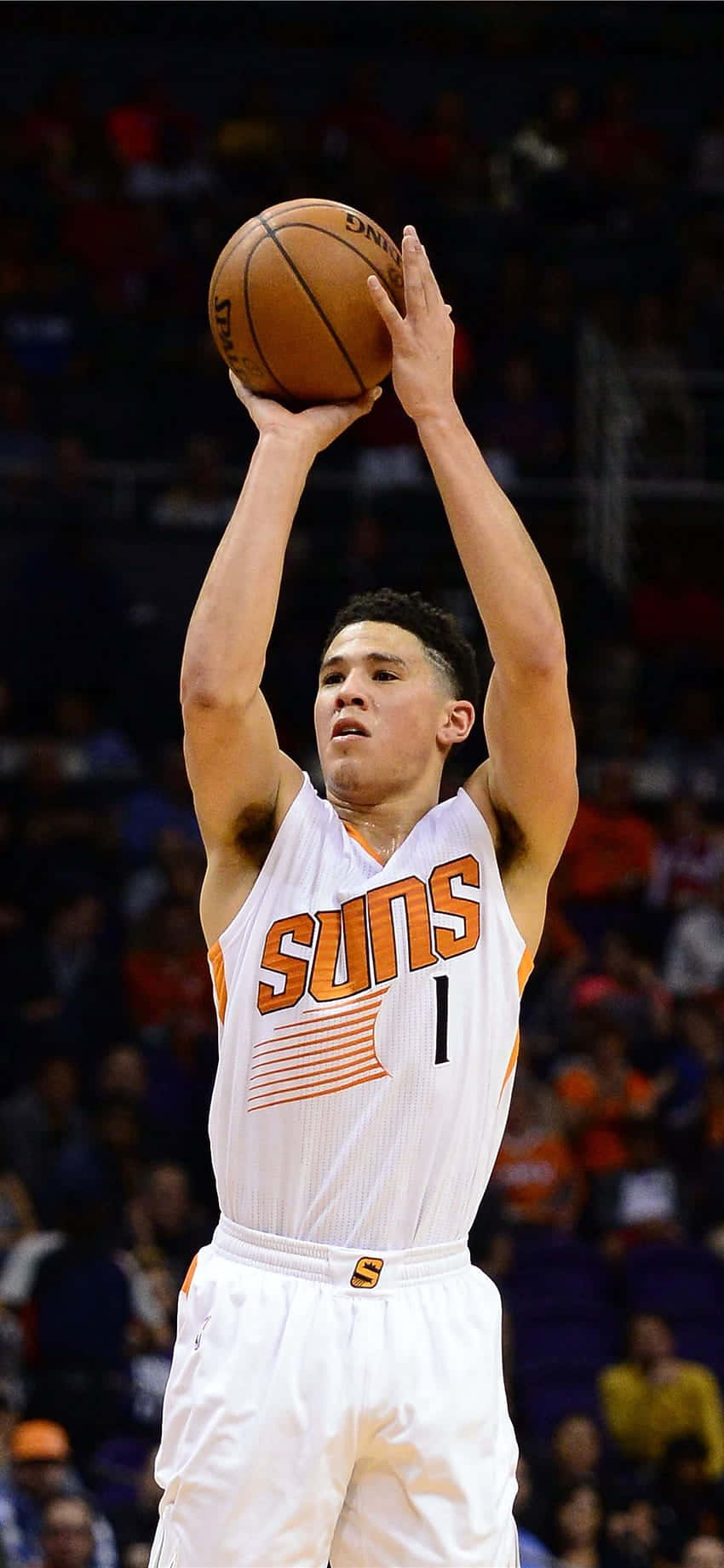 Devin Booker Shooting A Jump Shot With Iphone In Hand Background