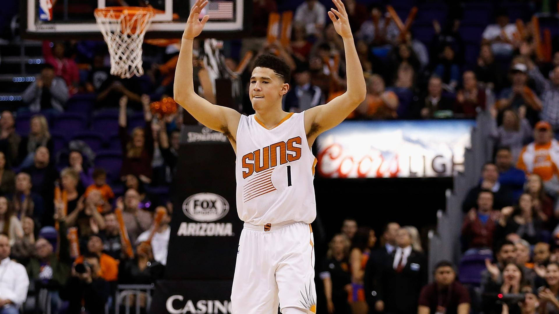 Devin Booker With Raised Hands Background