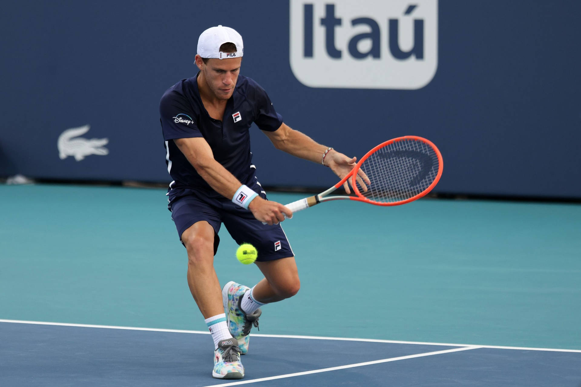 Diego Schwartzman Hitting The Ball Background