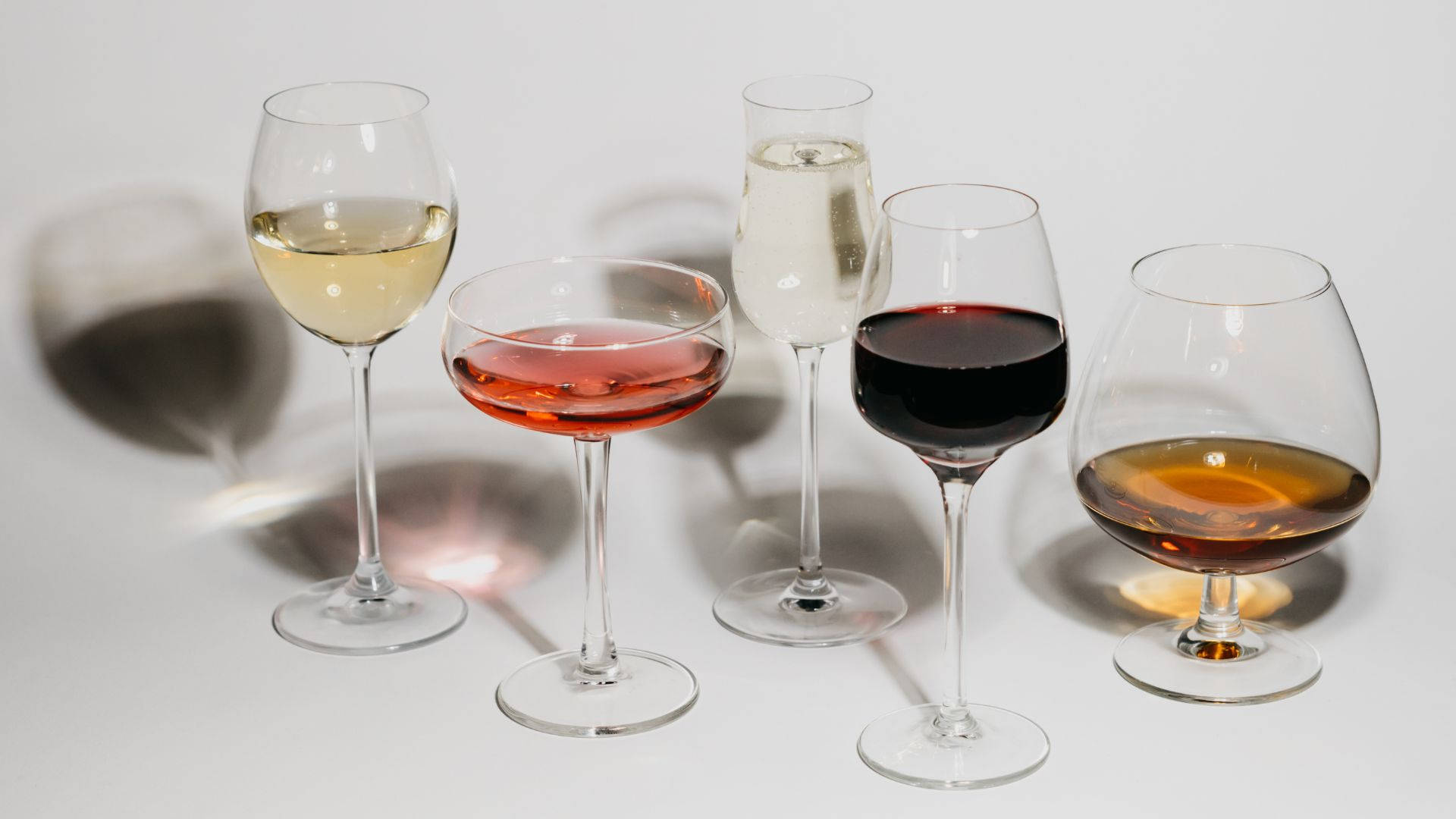 Different Colored Alcohol On Wine Glasses Background