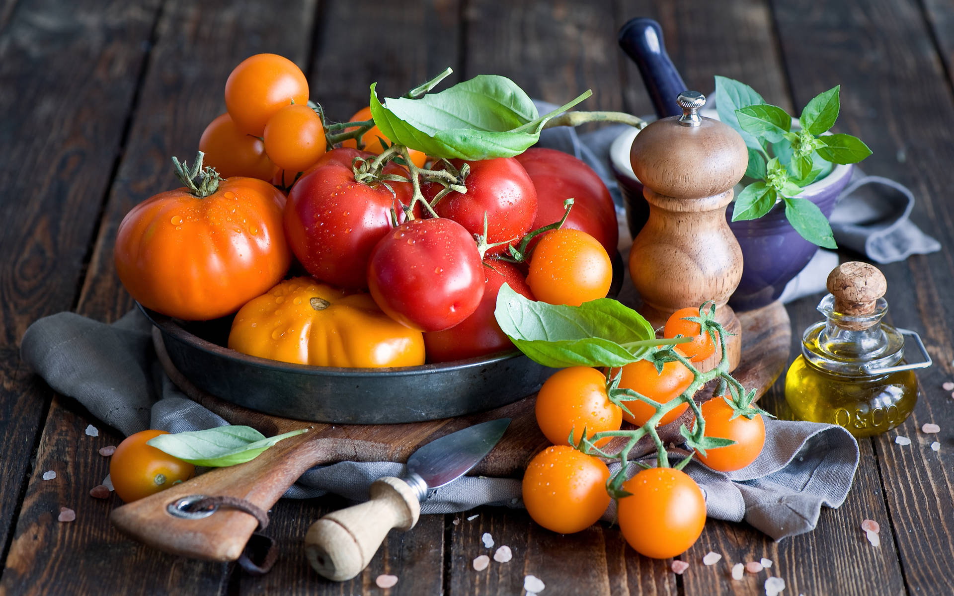 Different Tomato Fruits On Wooden Table