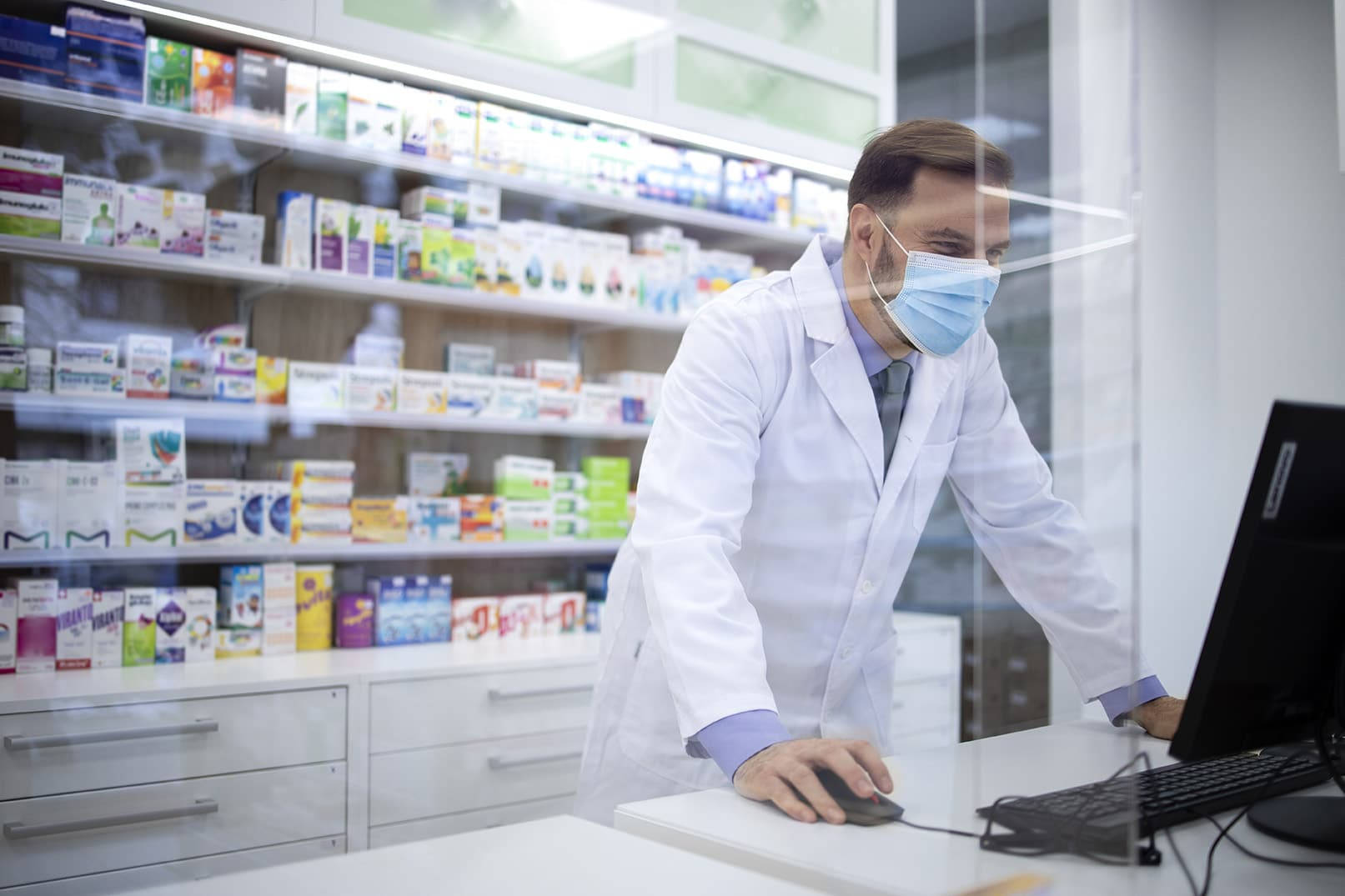 Diligent Pharmacist At Work During Pandemic Background