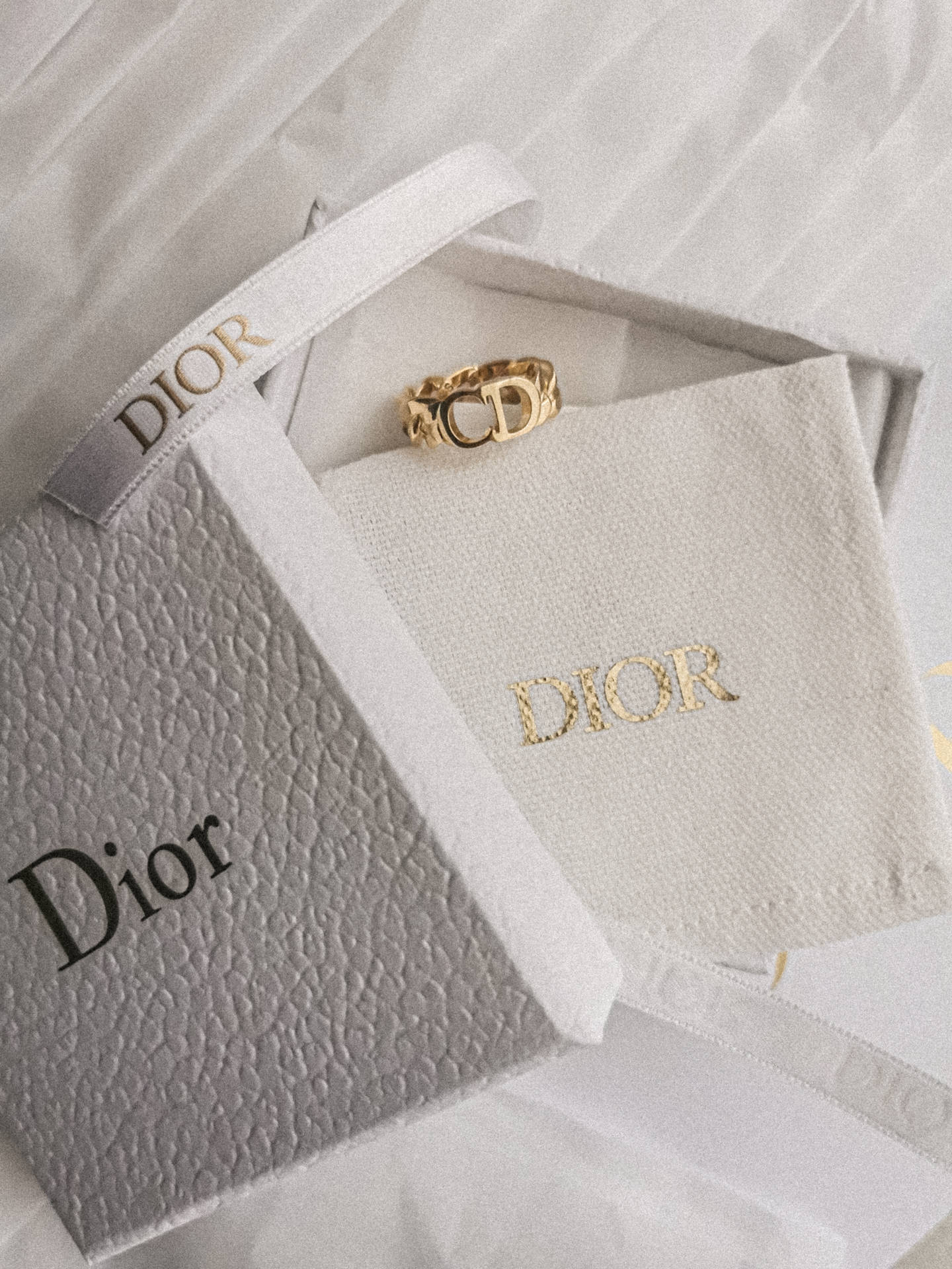 Dior Gold Ring And Gift Box Background
