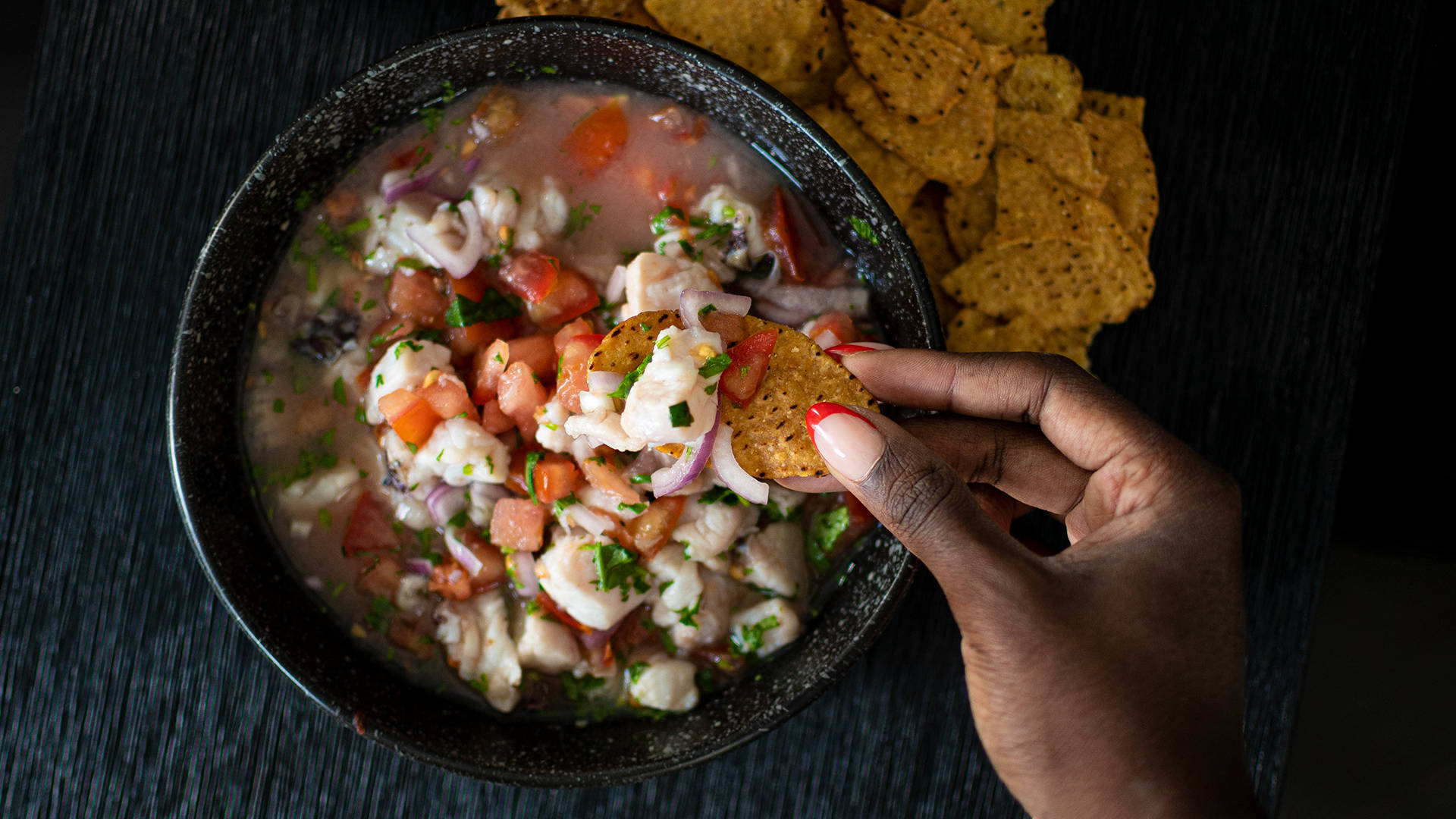 Dipping Corn Chips In Ceviche Background