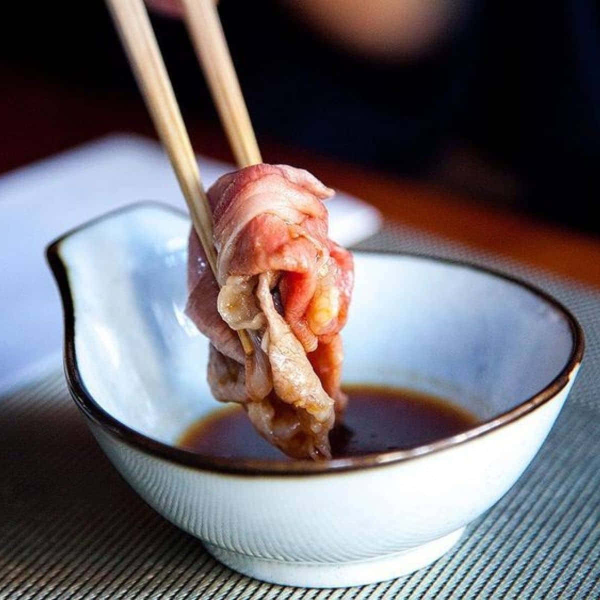 Dipping The Meat In A Shabu-shabu Sauce Background