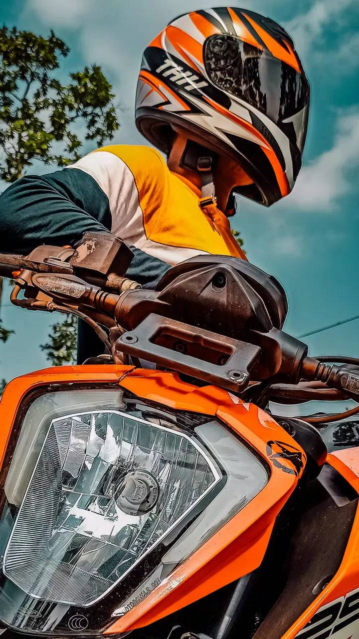 Discover The Thrill: Orange Ktm Racer With Versatile Iphone