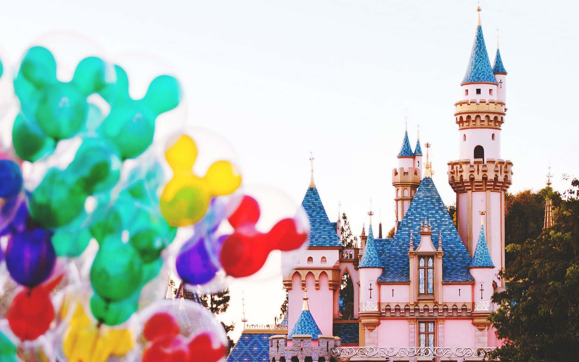 Disney's Cinderella Castle With Colorful Balloons In Front Of It Background