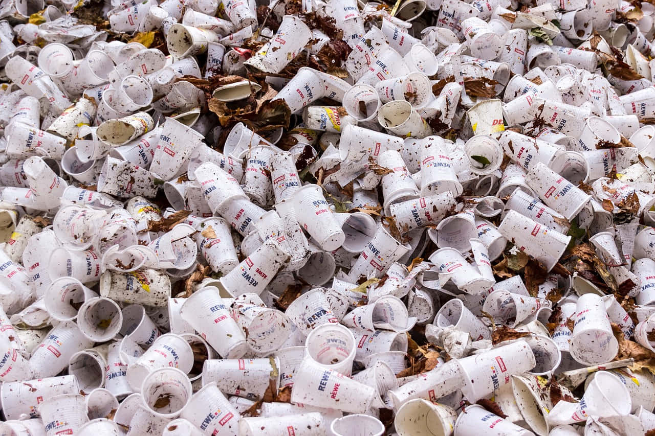 Disposable Cups In The Trash Background