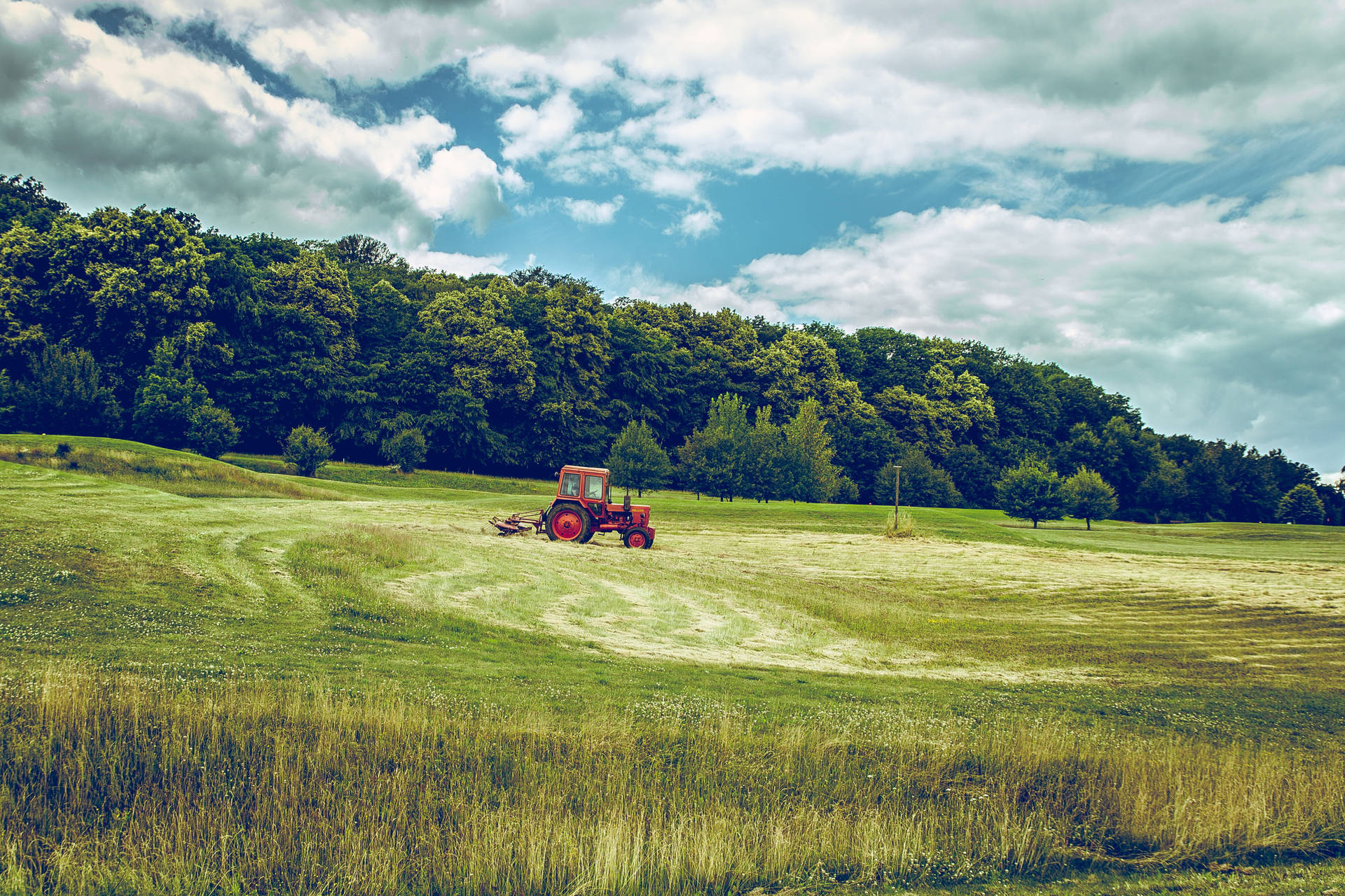 Distant Tractor On The Field Background