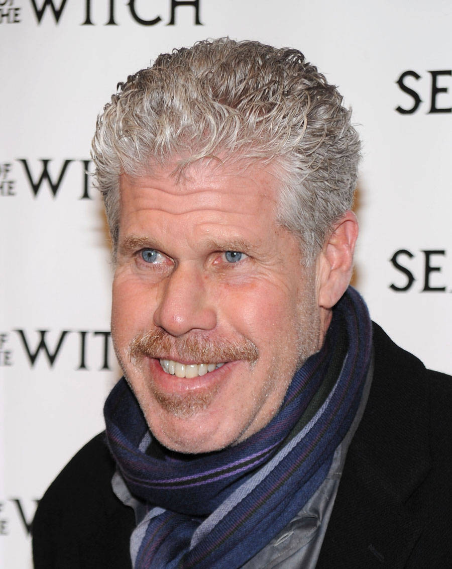 Distinguished Actor Ron Perlman Donning A Stylish Scarf. Background