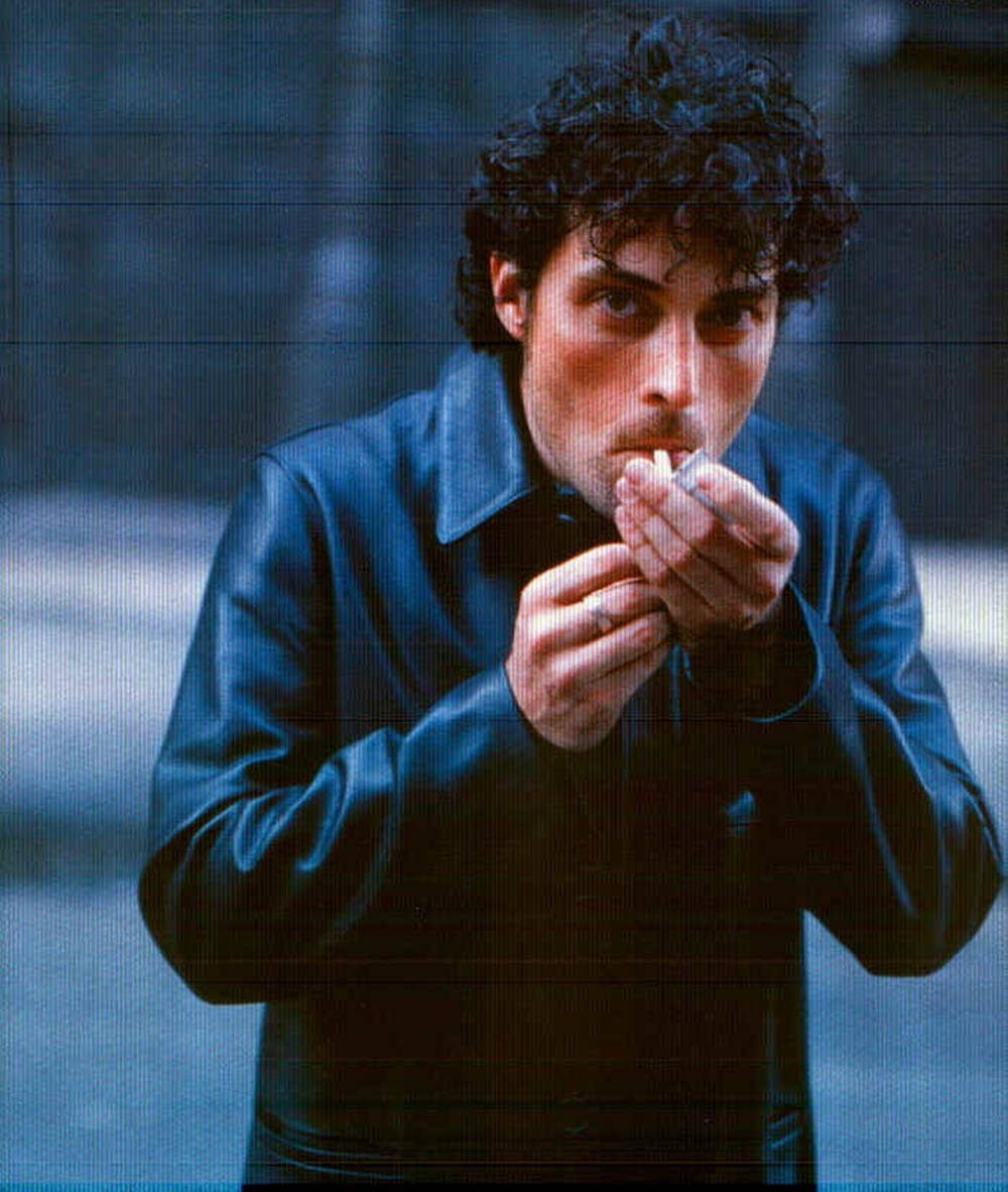 Distinguished Actor Rufus Sewell Enjoying A Smoke Break Background