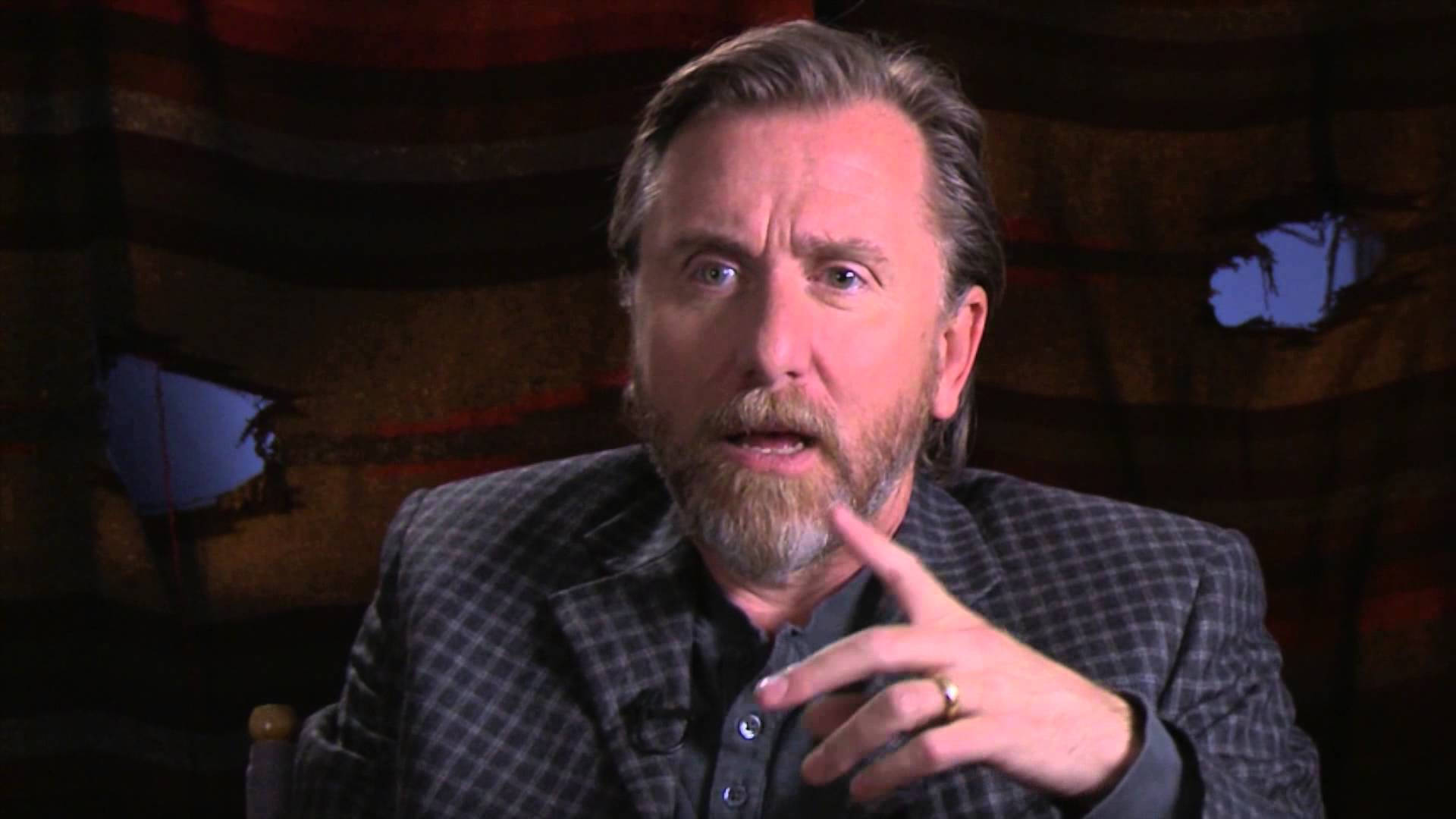 Distinguished British Actor Tim Roth Posing In A Stylish Checkered Suit.