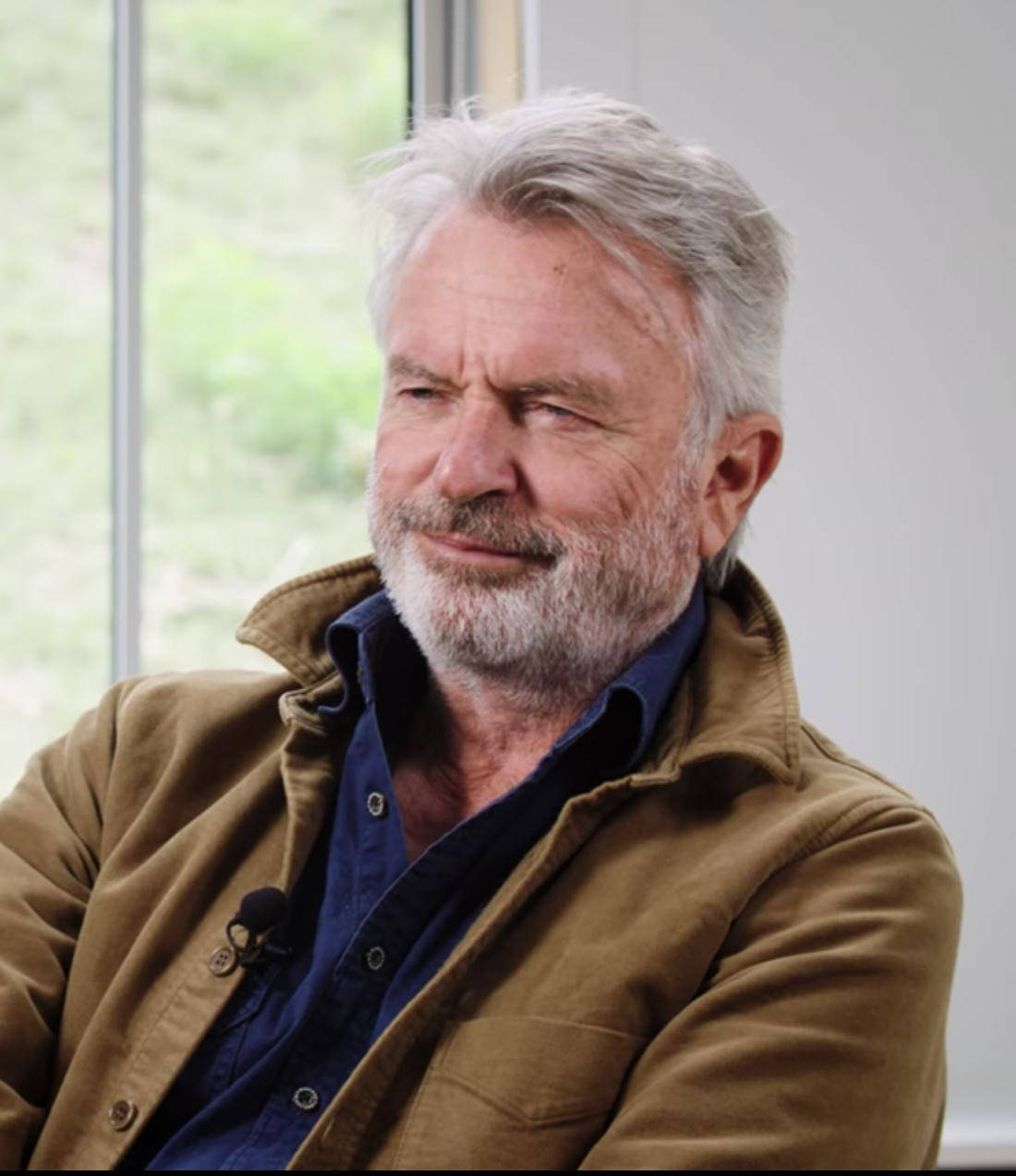 Distinguished New Zealand Actor Sam Neill In A Side View Shot. Background