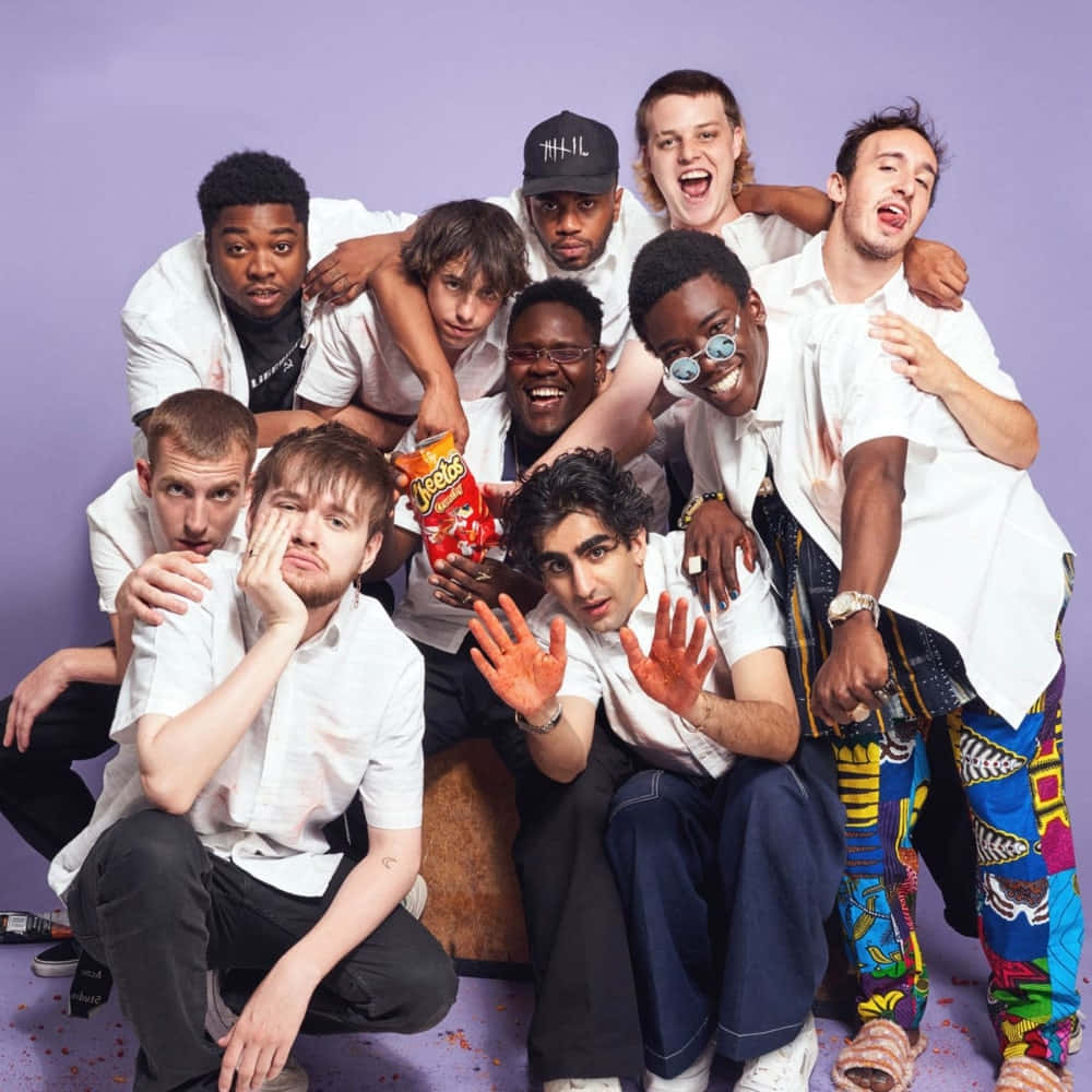 Diverse Group Of Brockhampton Members On A Rooftop Background