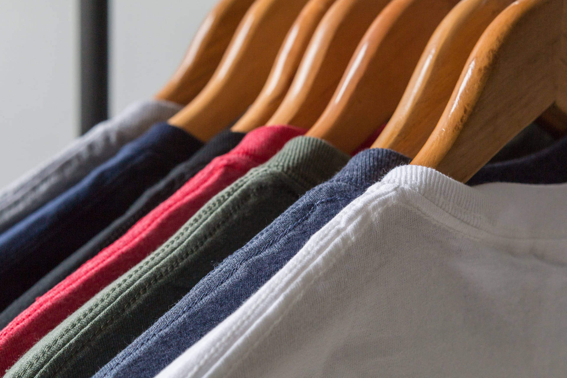 Diverse Selection Of Blank Shirts On A Rack Background