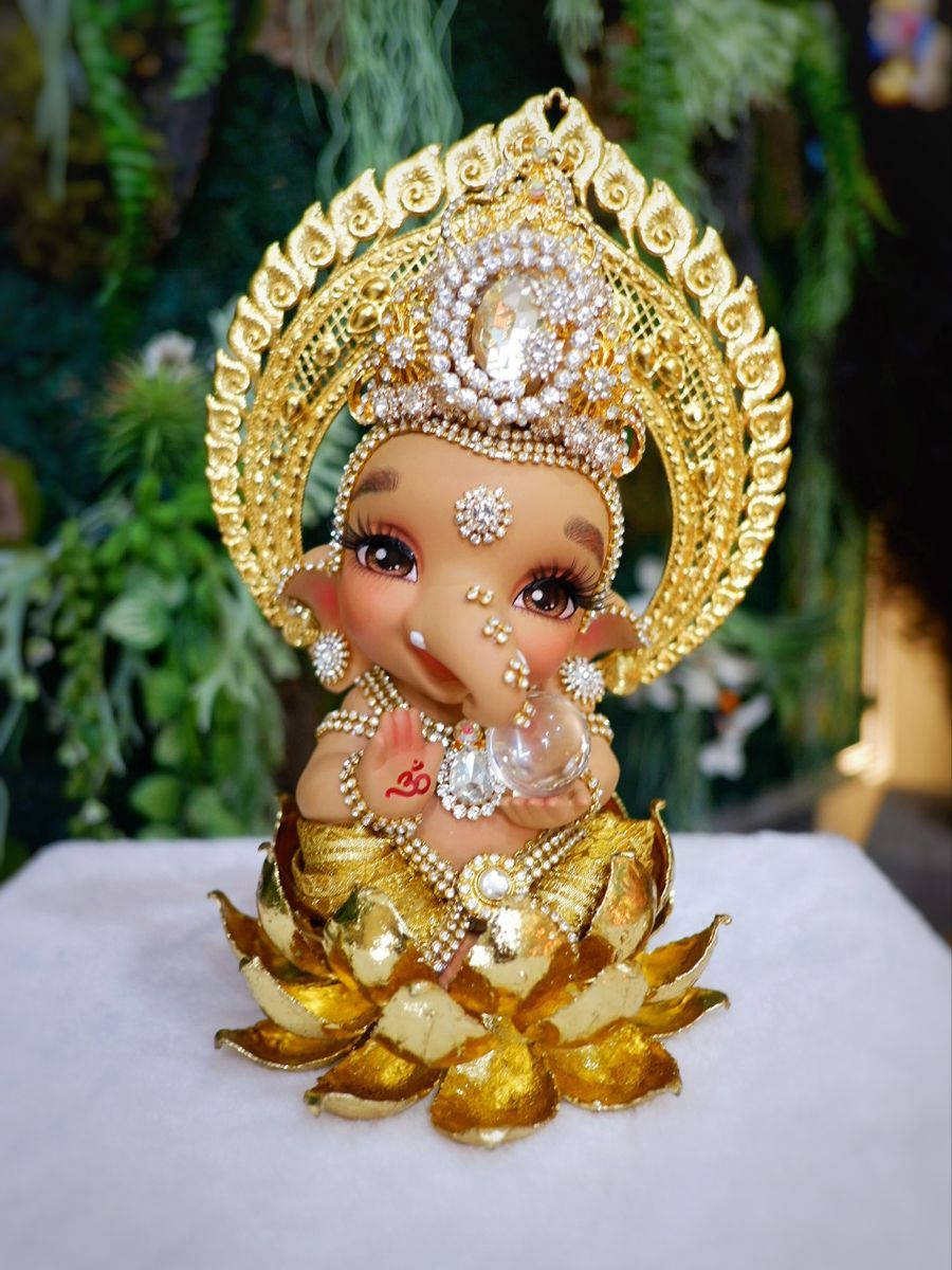 Divine Baby Ganesh Golden Figurine Background