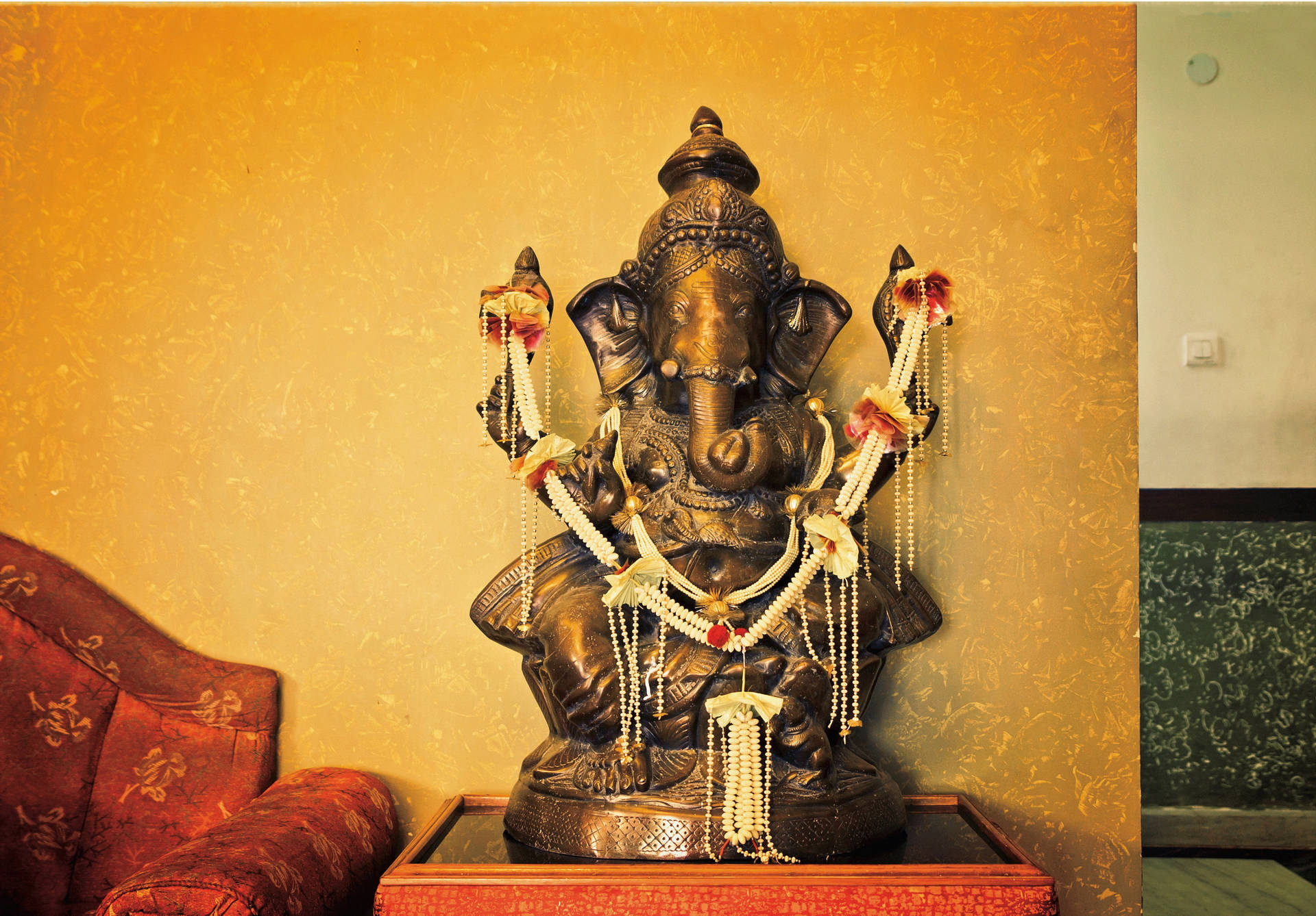 Divine Bronze Statue Of Lord Ganesh Background