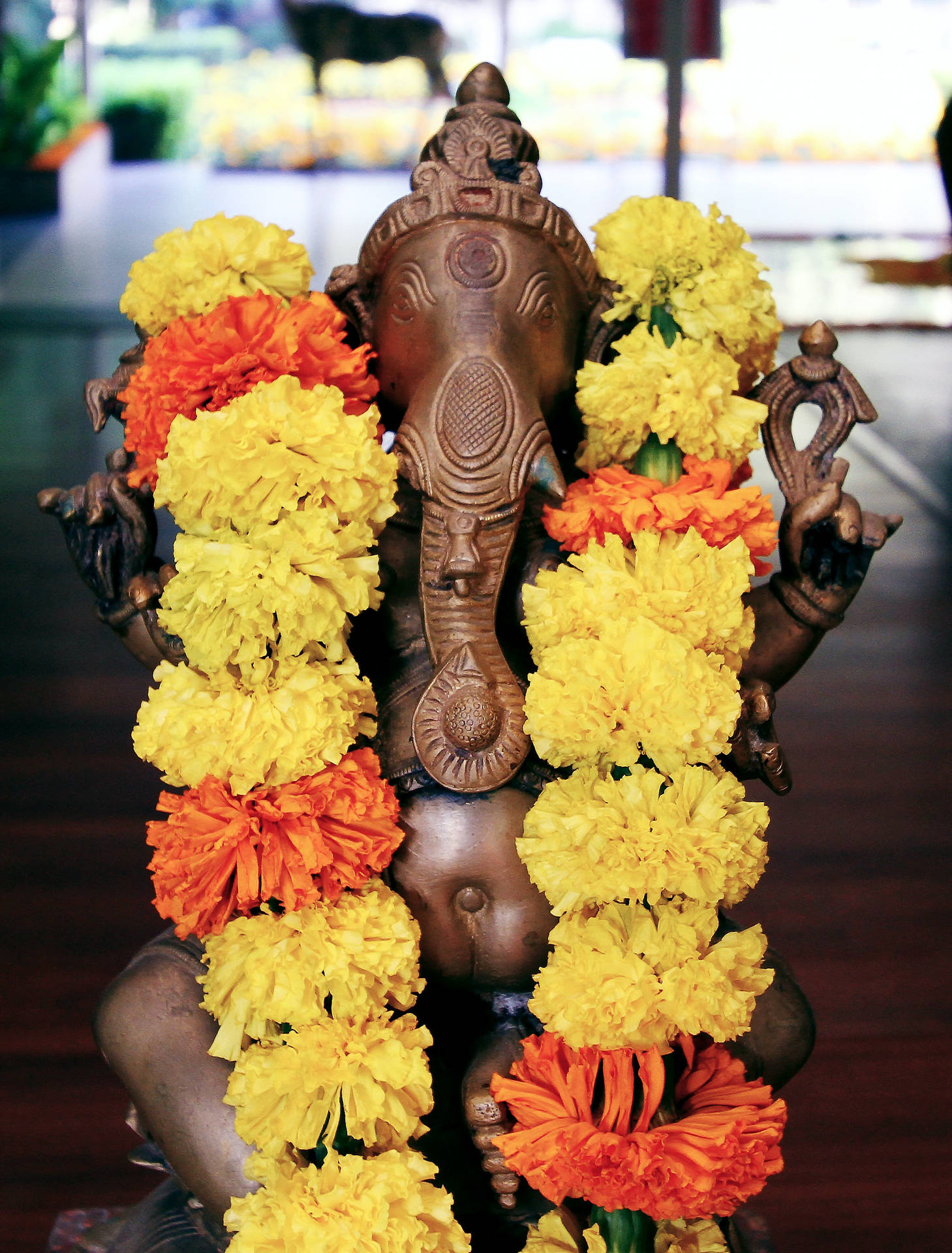 Divine Ganesha With Marigold Garland On Mobile Background