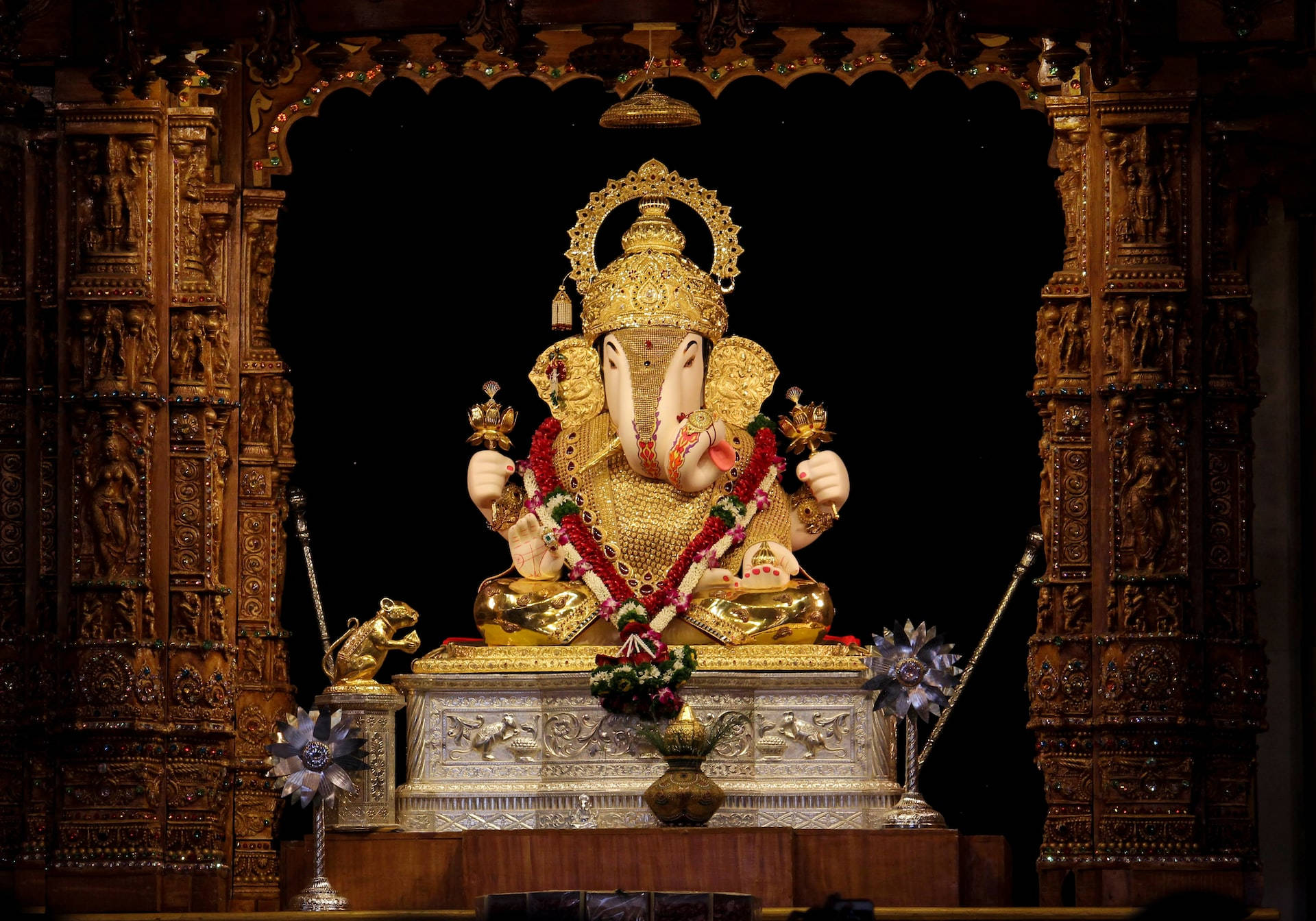 Divine Golden Ganesha Statue On Desktop Background