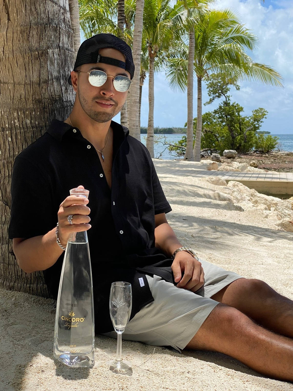 Dj Crespo With Cincoro Tequila At Beach Background