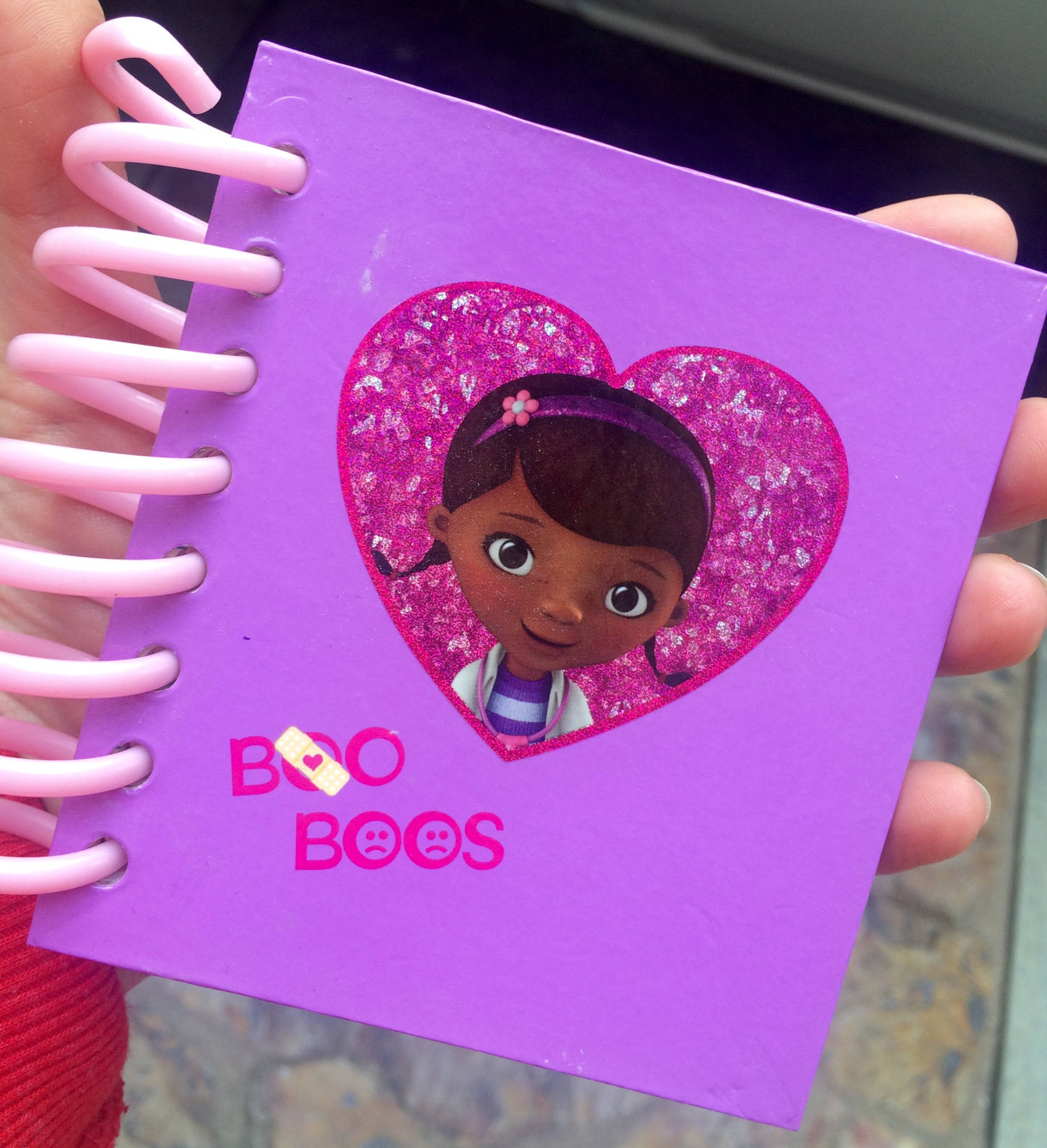Doc Mcstuffins With Her Big Book Of Boo-boos Background