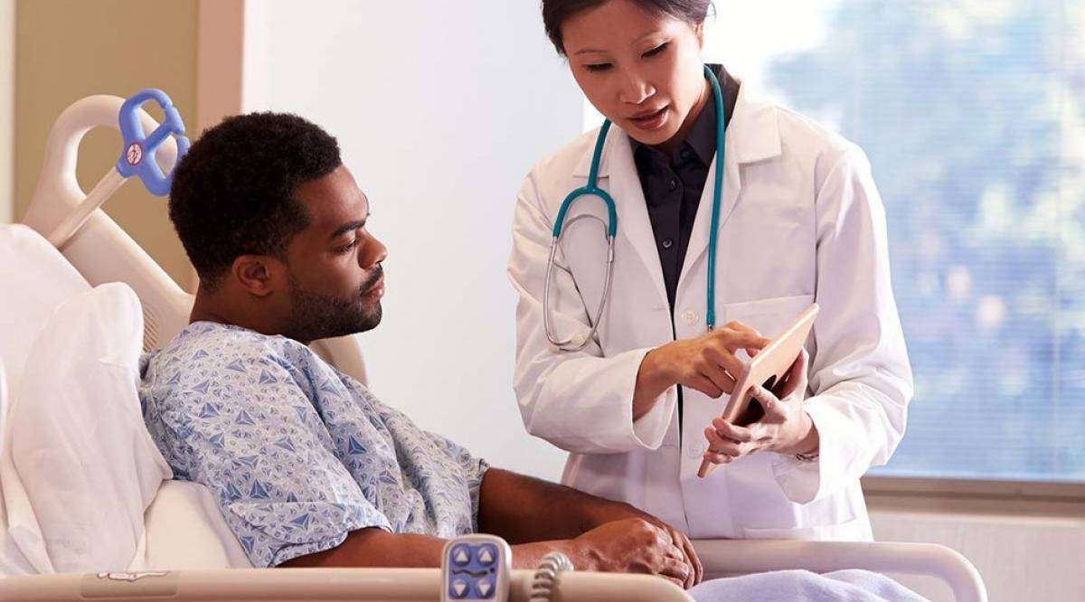 Doctor And Patient Reading Off Tablet