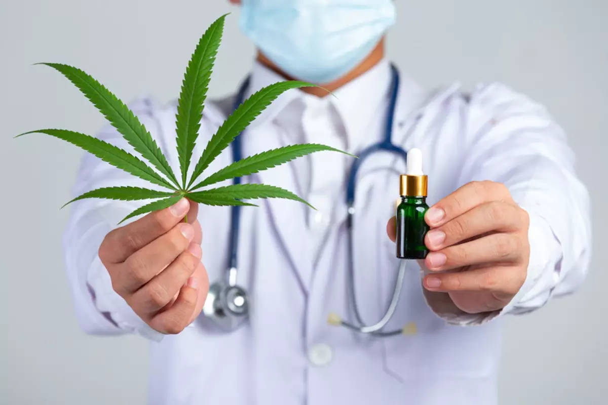 Doctor Holding Weed Leaf And Bottle Background