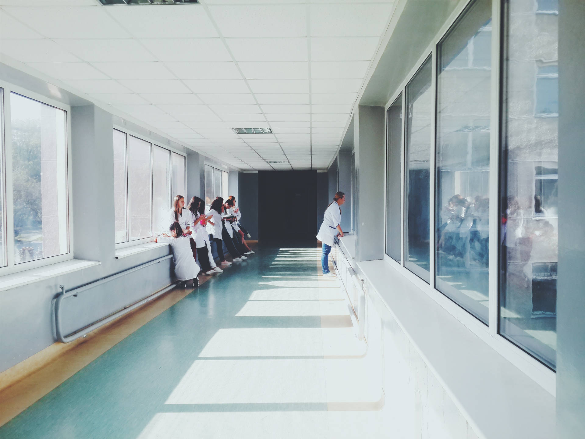 Doctors Observing In The Hallway Background