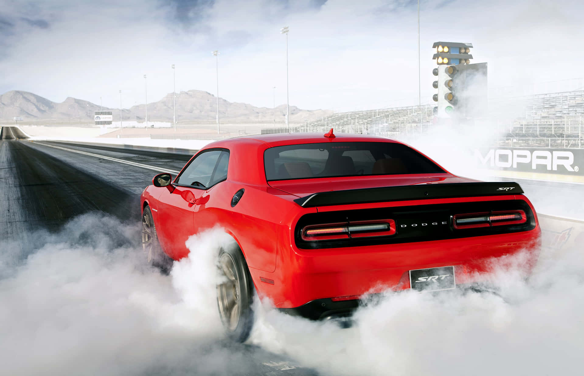 Dodge Challenger Srt - A Red Car Driving Down A Track