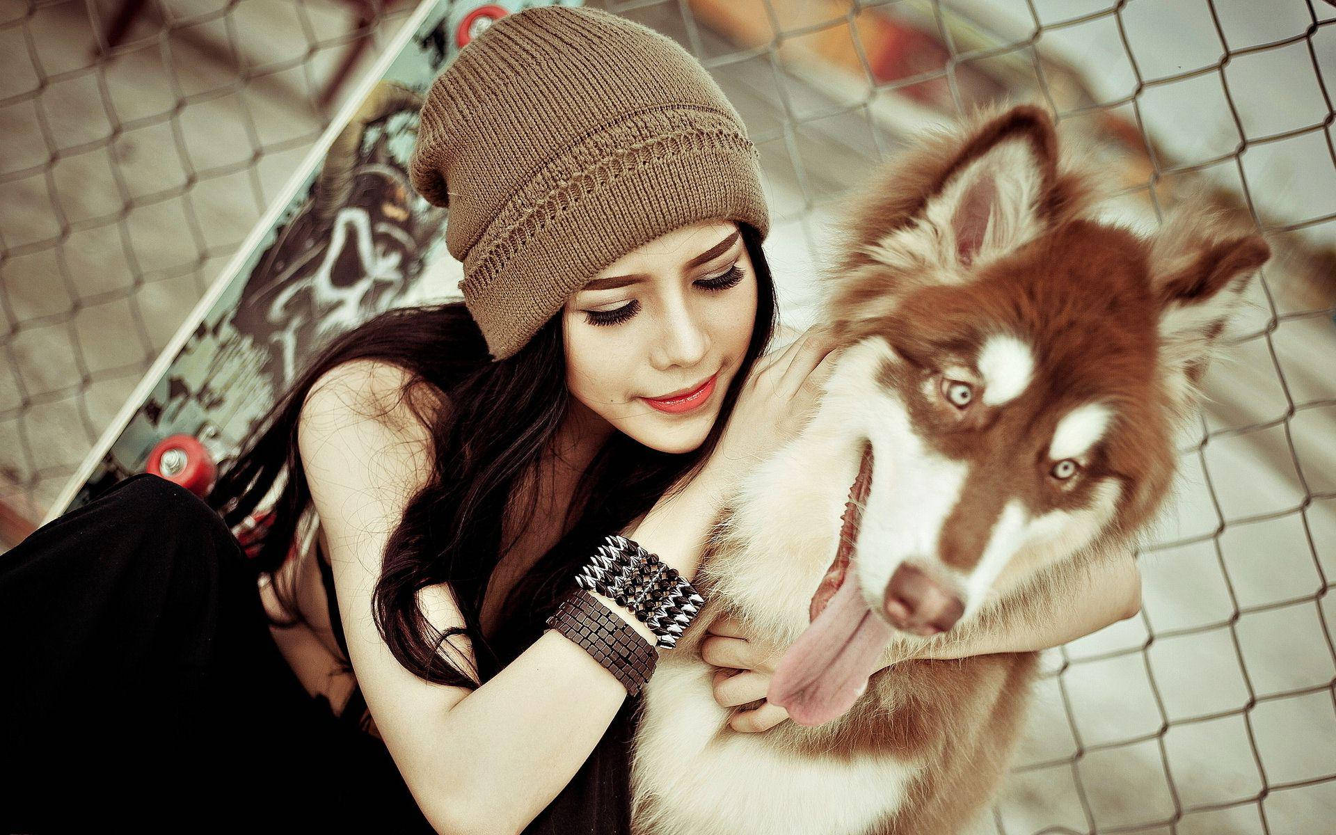 Dog And Girl Hugging A Siberian Background