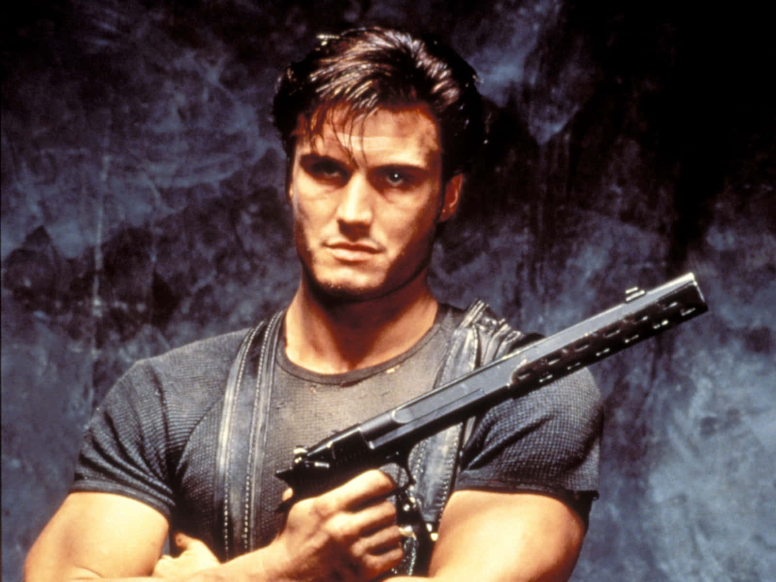 Dolph Lundgren Striking A Powerful Pose Background