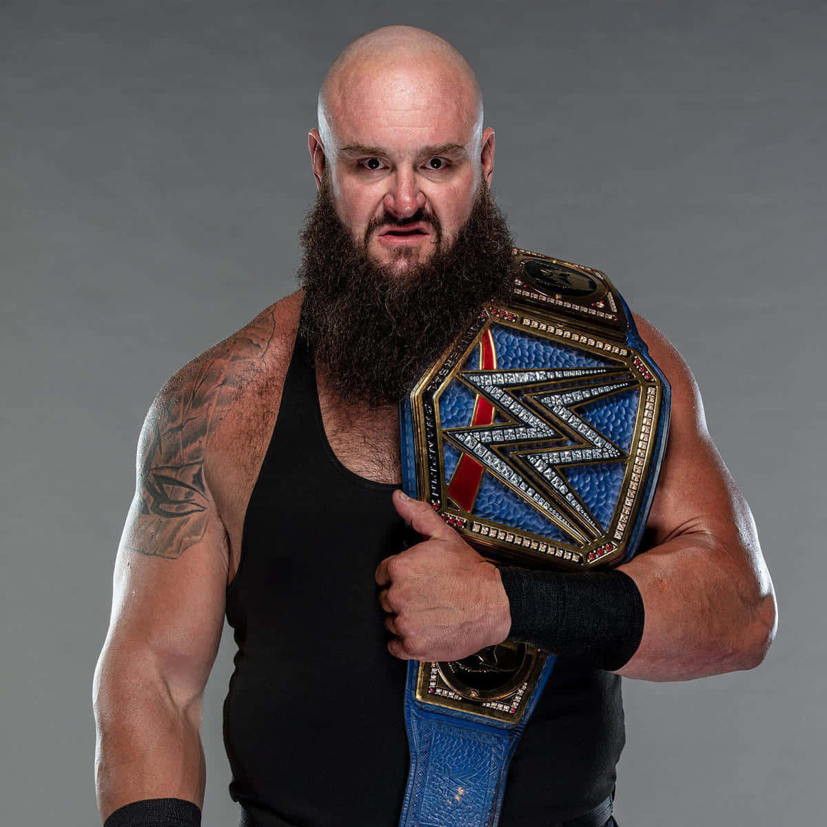 Dominant Force In Wwe, Braun Strowman, Hoisting His Championship Belt Background