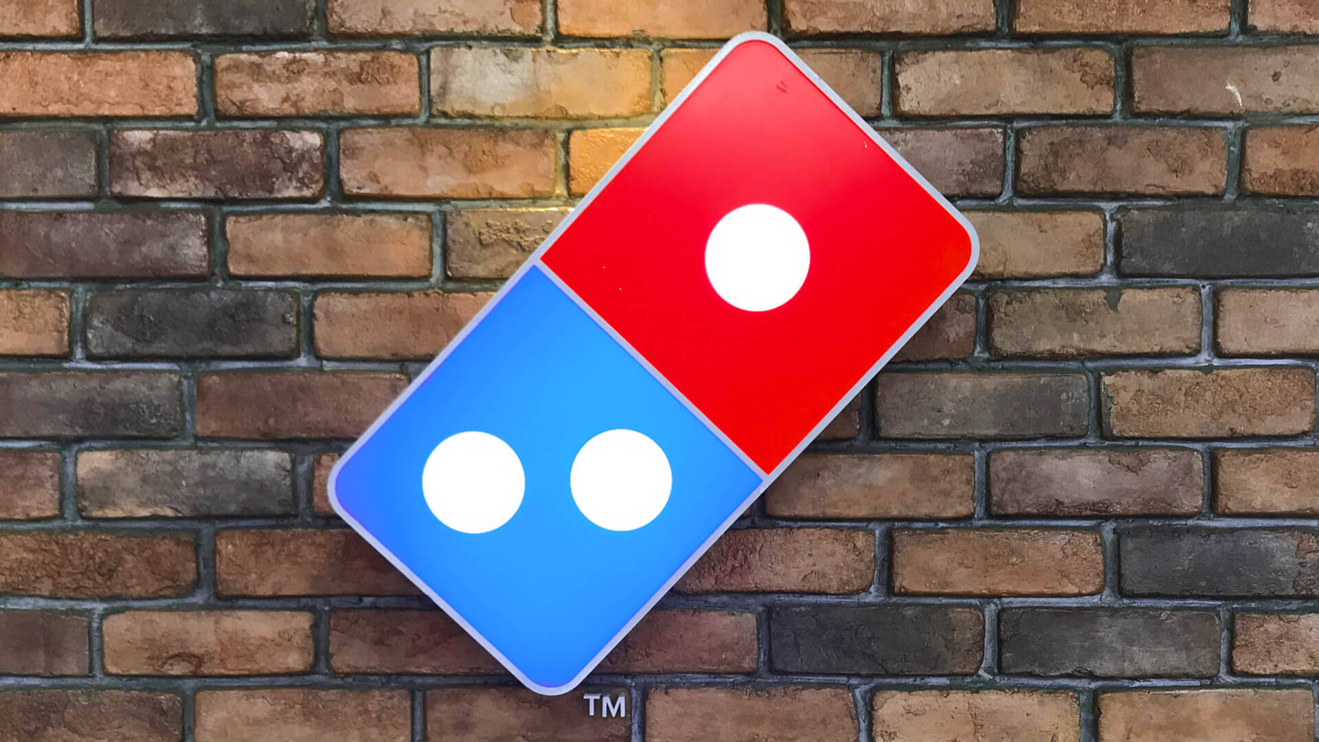 Dominos Pizza Logo On Brick Wall Background
