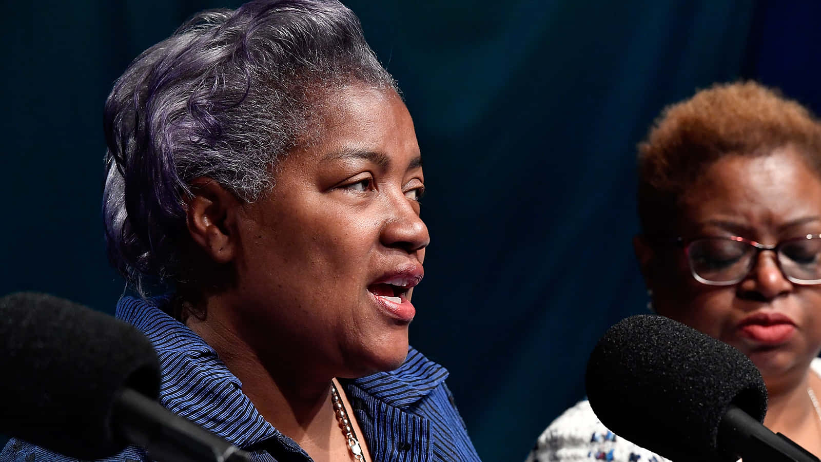 Donna Brazile Delivering An Empowering Speech Background