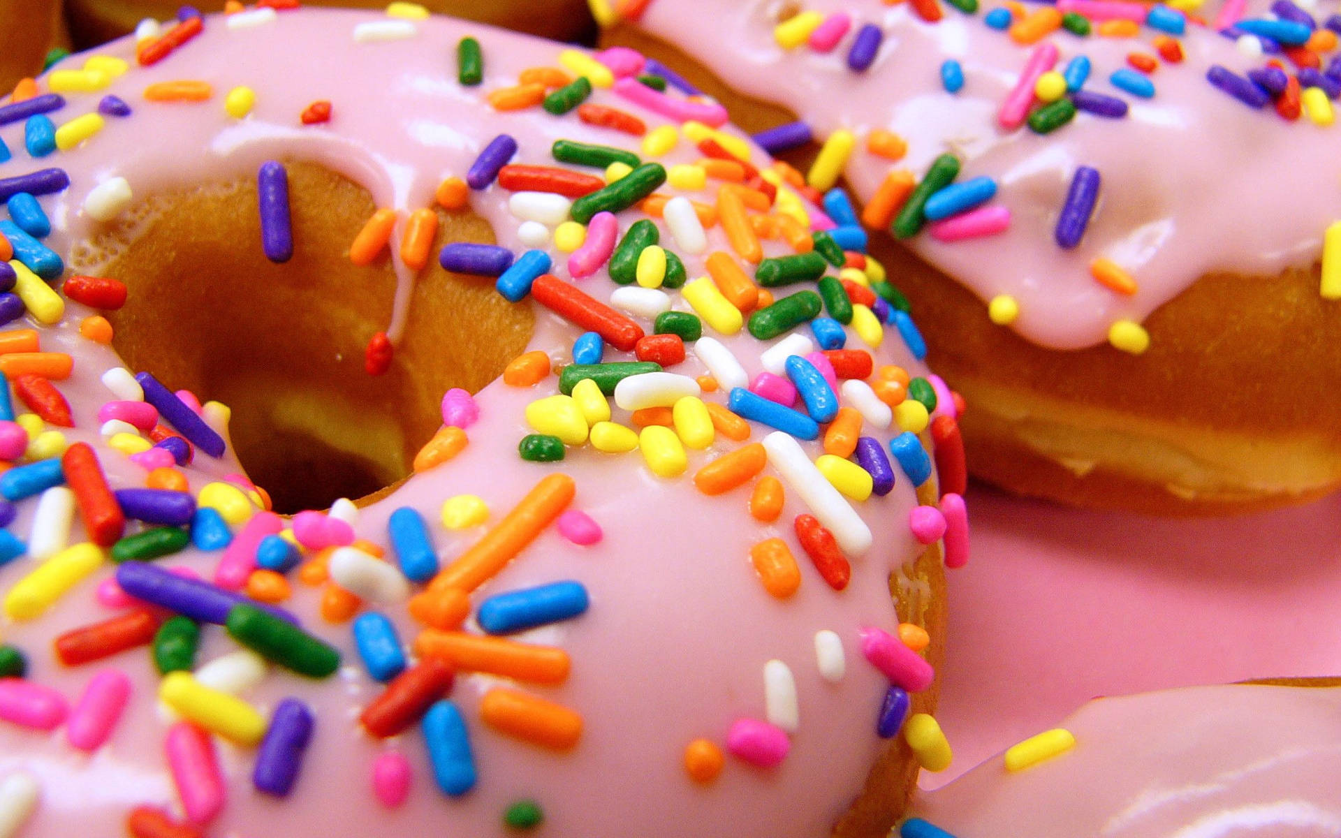 Doughnuts With Candy Sprinkles Background