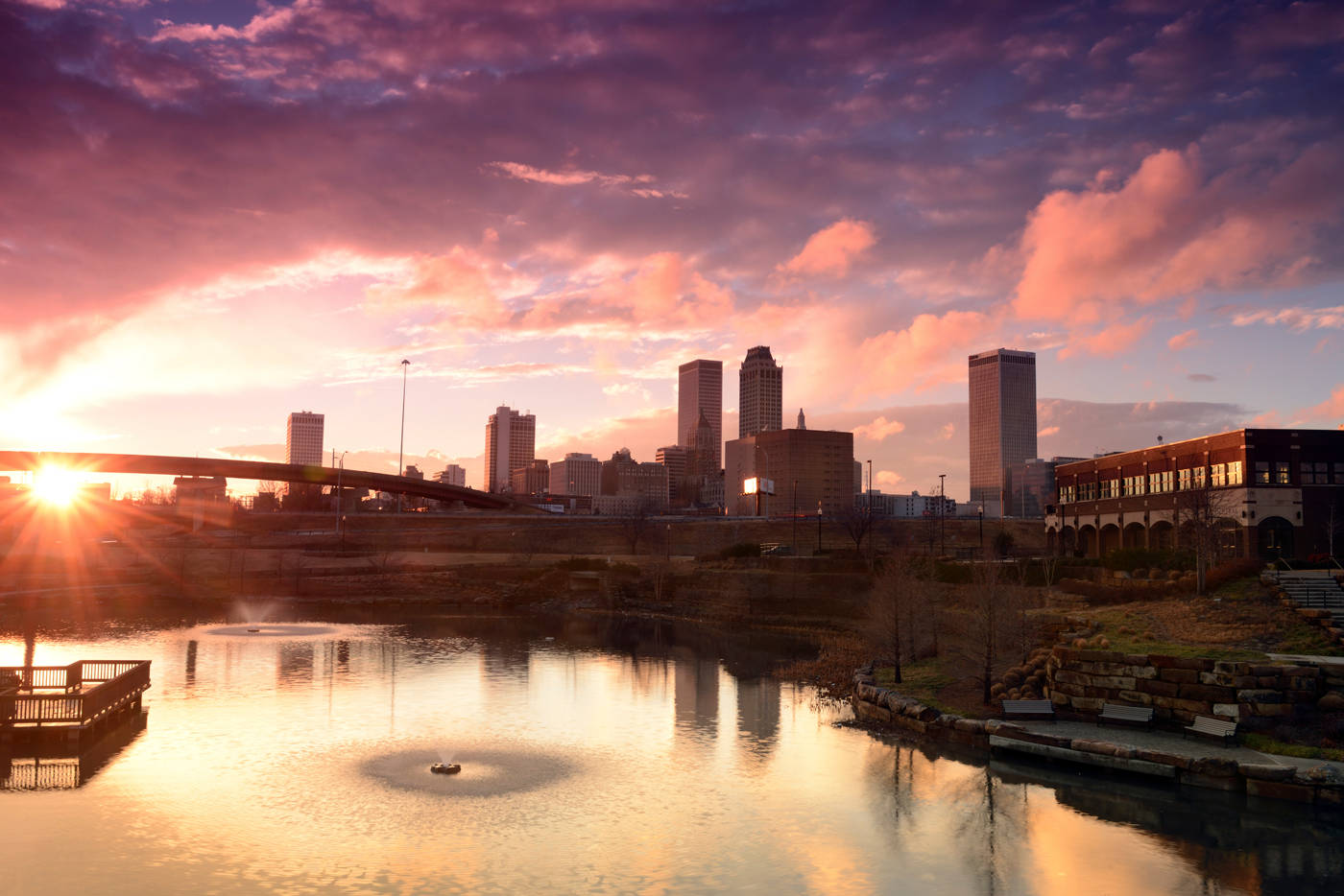 Downtown Tulsa With Body Of Water Background