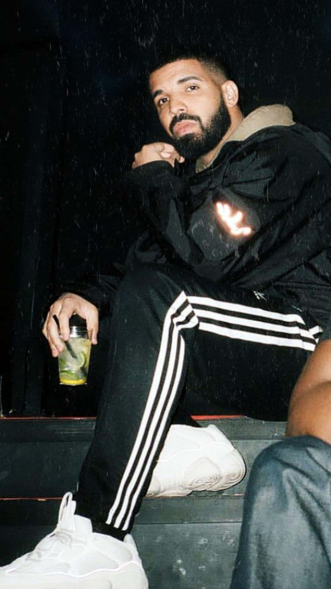 Drake And A Man Sitting On A Step