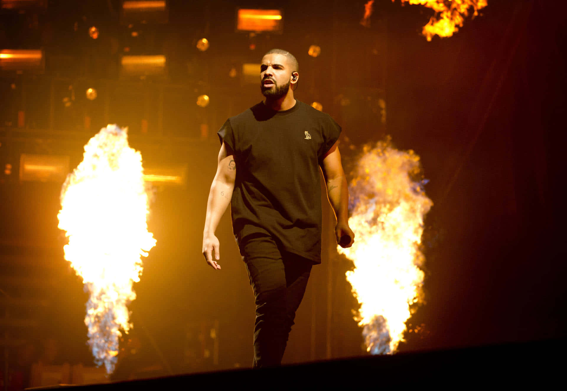 Drake Is Walking On Stage With Flames Background
