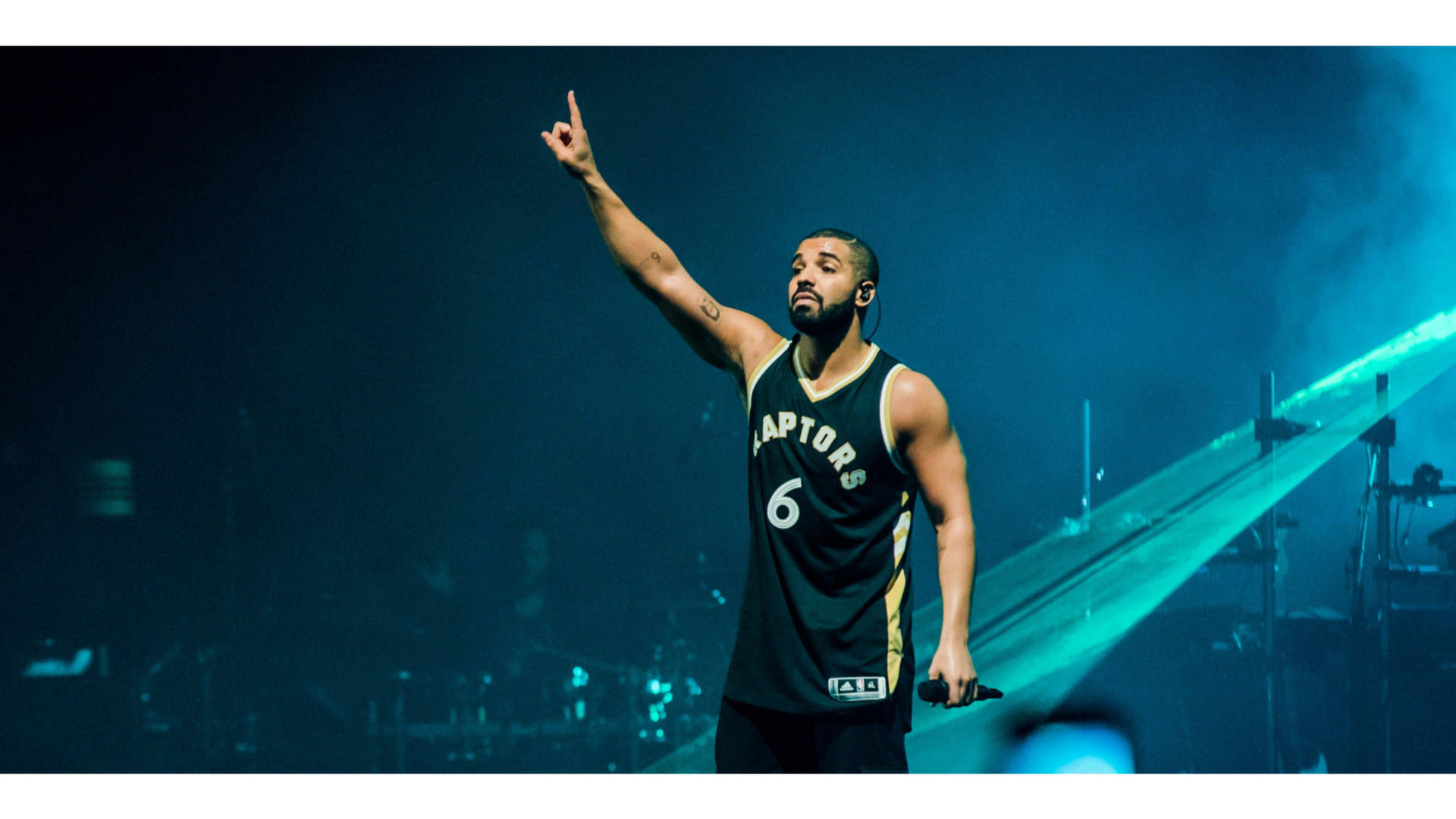 Drake Rocking In His Ovo Raptors Jersey Background